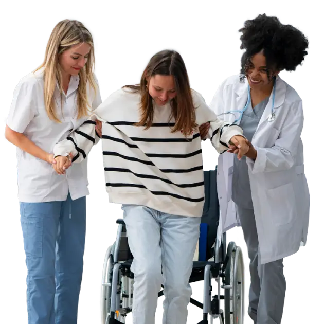 A female patient helper and a nurse help a young woman out of a wheel chair